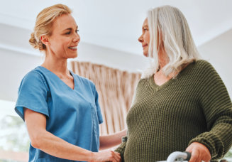 nurse assisting elderly woman