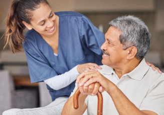 nurse and elderly man smiling