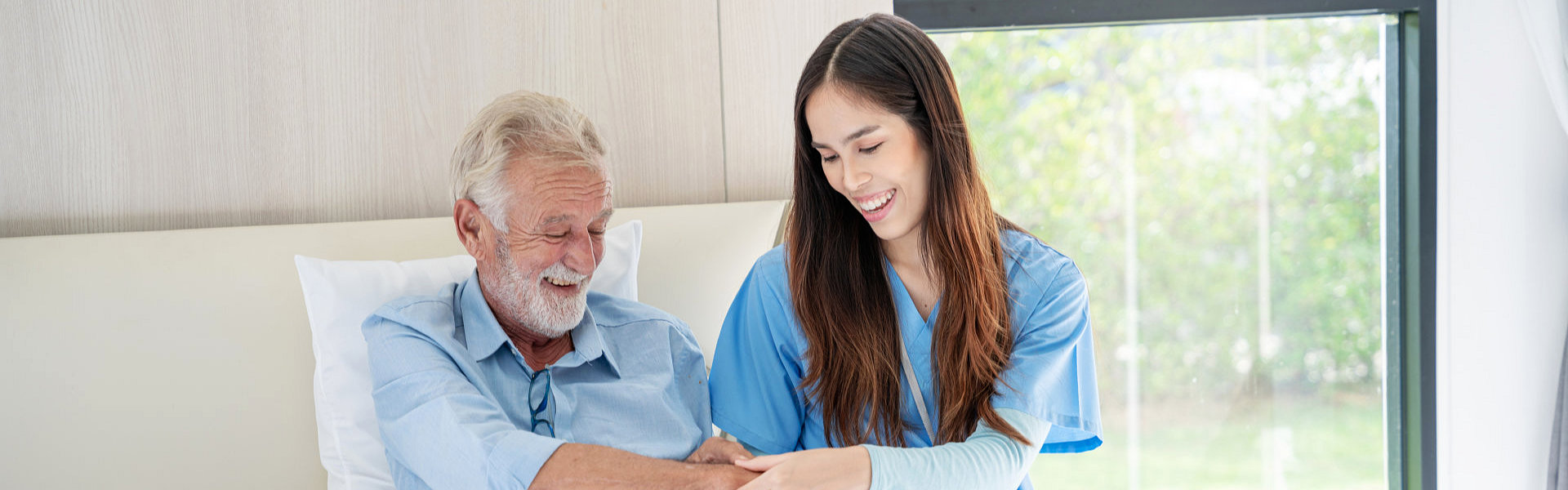 nurse assisting elderly man