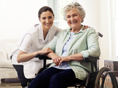 nurse and elderly woman looking at the camera