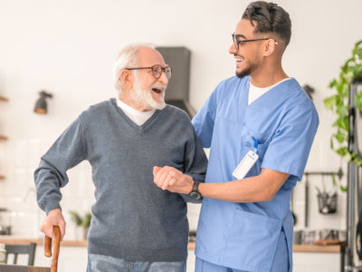 nurse and elderly man laughing