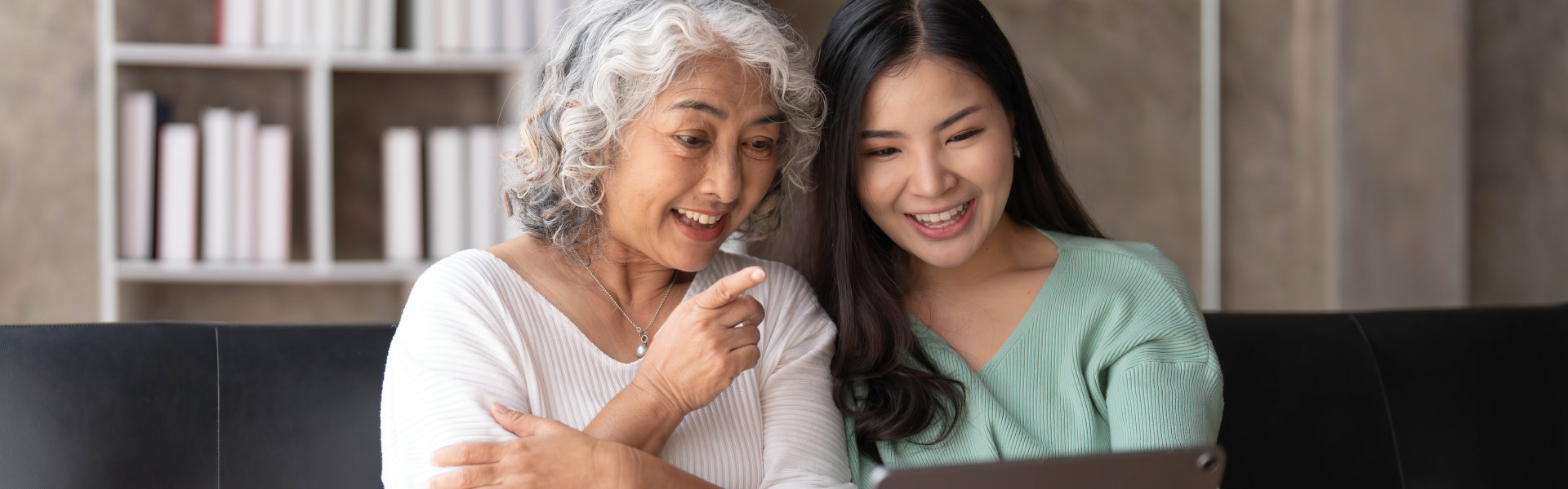 woman and elderly using tablet