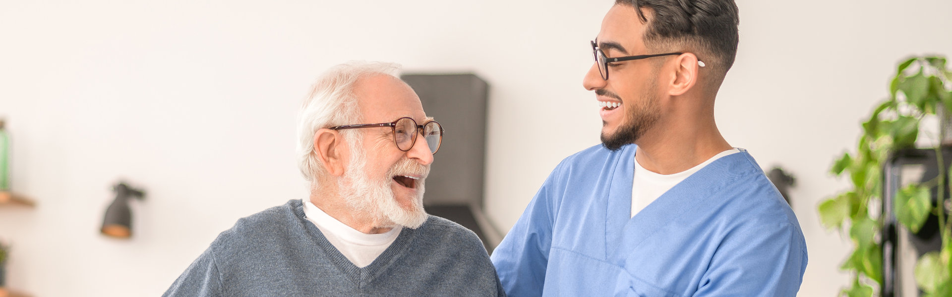 nurse and elderly man laughing