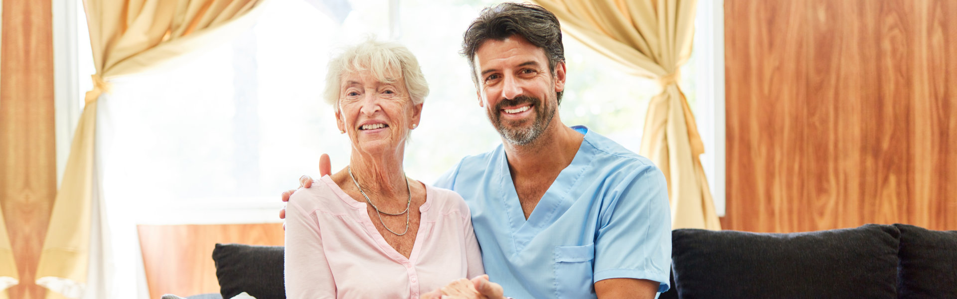 nurse and elderly looking at the camera